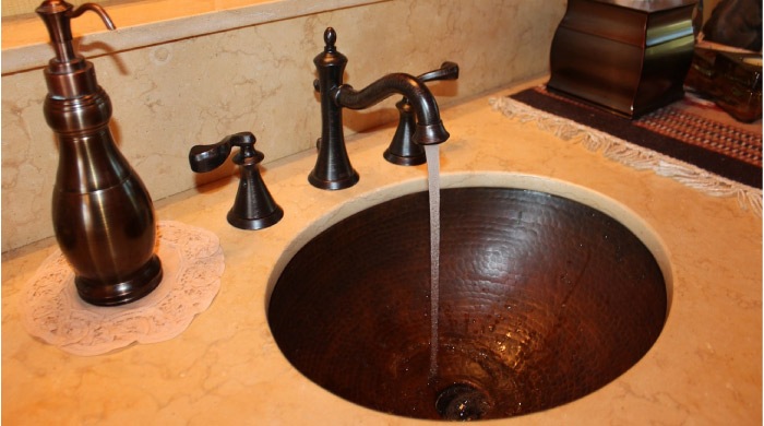 copper bathroom faucet running water
